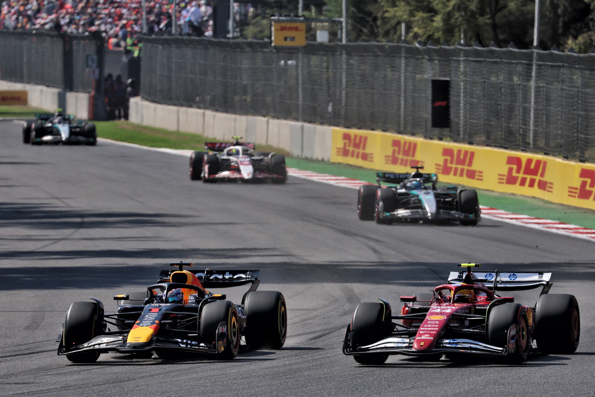 Max Verstappen (NLD) Red Bull Racing RB21 and Lewis Hamilton (GBR) Ferrari SF-25 battle for position.