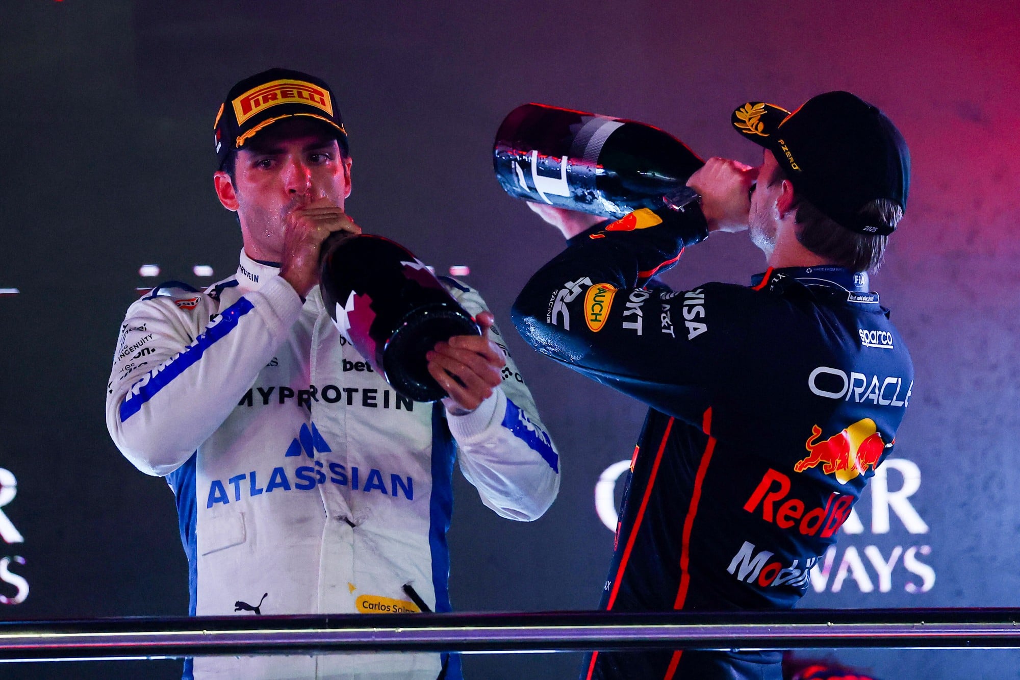 LUSAIL CITY, QATAR - NOVEMBER 30: Race winner Max Verstappen of the Netherlands and Oracle Red Bull Racing and Third placed Carlos Sainz of Spain and Williams drink Champagne on the podium during the F1 Grand Prix of Qatar at Lusail International Circuit on November 30, 2025 in Lusail City, Qatar. (Photo by Mark Thompson/Getty Images) // Getty Images / Red Bull Content Pool // SI202511300654 // Usage for editorial use only //