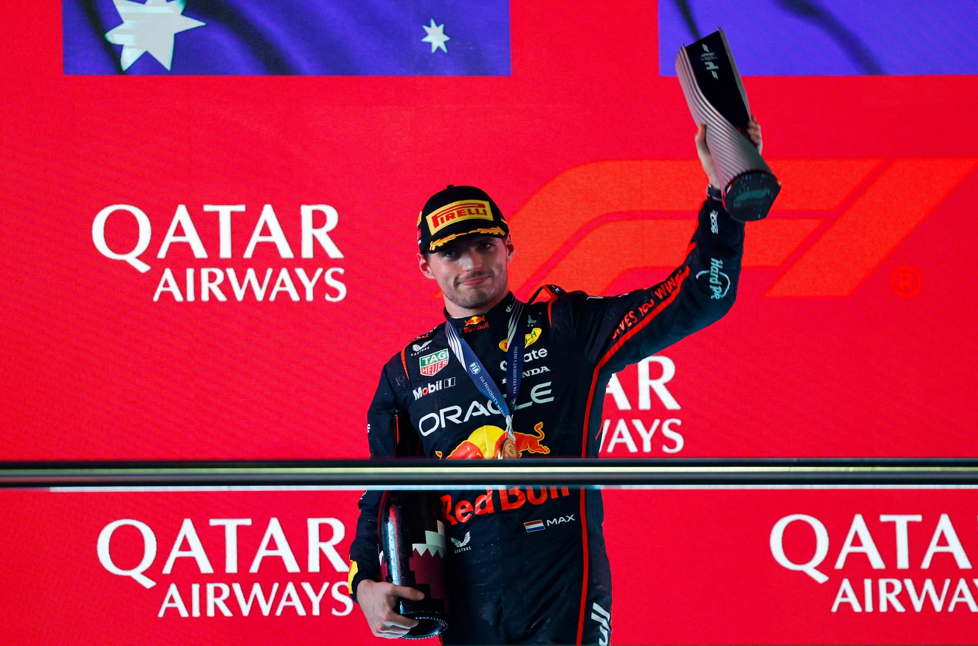 LUSAIL CITY, QATAR - NOVEMBER 30: Race winner Max Verstappen of the Netherlands and Oracle Red Bull Racing on the podium with his trophy during the F1 Grand Prix of Qatar at Lusail International Circuit on November 30, 2025 in Lusail City, Qatar. (Photo by Andrew Ferraro/LAT Images) // Getty Images / Red Bull Content Pool // SI202511300670 // Usage for editorial use only //