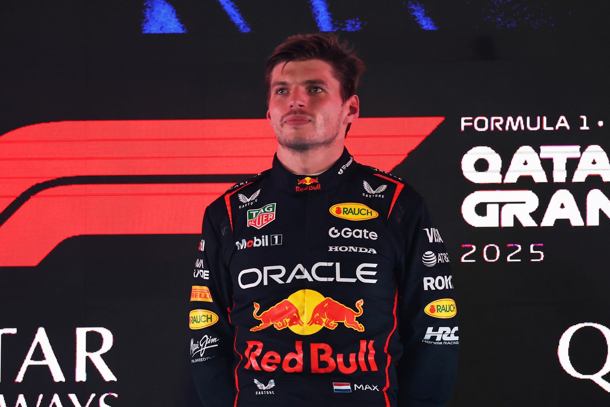 LUSAIL CITY, QATAR - NOVEMBER 30: Race winner Max Verstappen of the Netherlands and Oracle Red Bull Racing on the podium during the F1 Grand Prix of Qatar at Lusail International Circuit on November 30, 2025 in Lusail City, Qatar. (Photo by Lars Baron/LAT Images) // Getty Images / Red Bull Content Pool // SI202511300675 // Usage for editorial use only //