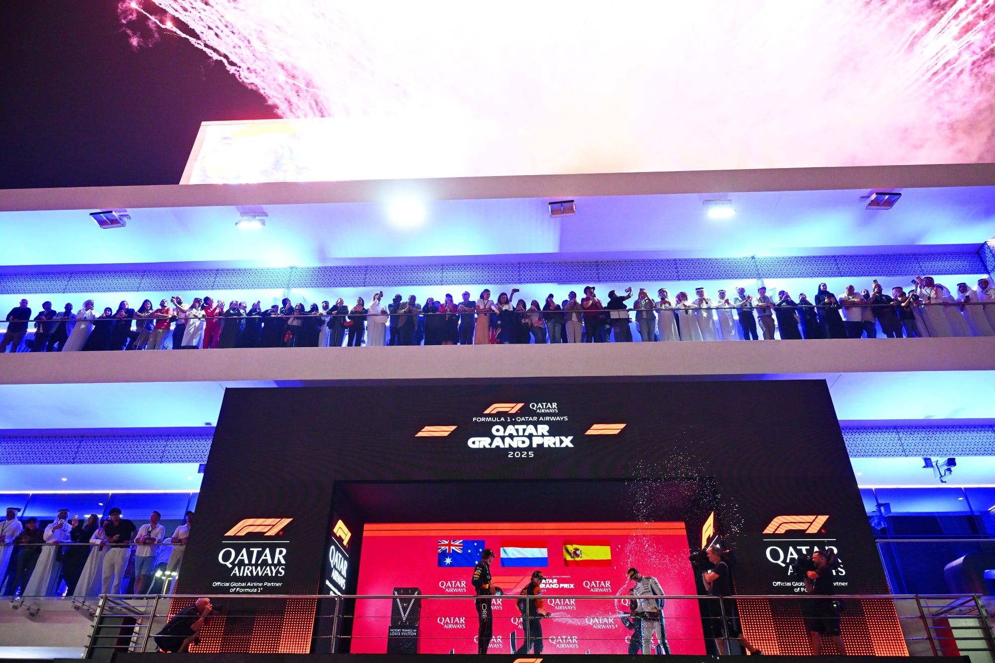 LUSAIL CITY, QATAR - NOVEMBER 30: Race winner Max Verstappen of the Netherlands and Oracle Red Bull Racing Second placed Oscar Piastri of Australia and McLaren Third placed Carlos Sainz of Spain and Williams and Hannah Schmitz, Principal Strategy Engineer of Oracle Red Bull Racing celebrate on the podium with Champagne during the F1 Grand Prix of Qatar at Lusail International Circuit on November 30, 2025 in Lusail City, Qatar. (Photo by Guido De Bortoli/LAT Images) // Getty Images / Red Bull Content Pool // SI202511300691 // Usage for editorial use only //