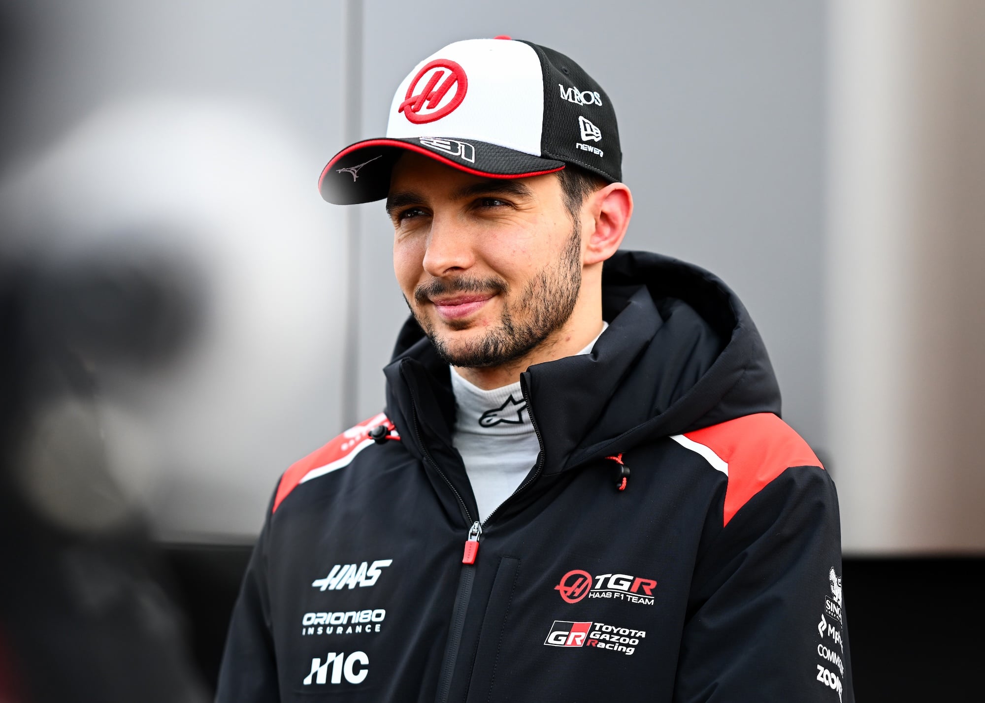 MONTMELO, SPAIN - JANUARY 26: Esteban Ocon of France and Haas F1 looks on in the Paddock during day one of F1 Testing at Circuit de Catalunya on January 26, 2026 in Montmelo, Spain. (Photo by Guido De Bortoli/LAT Images)