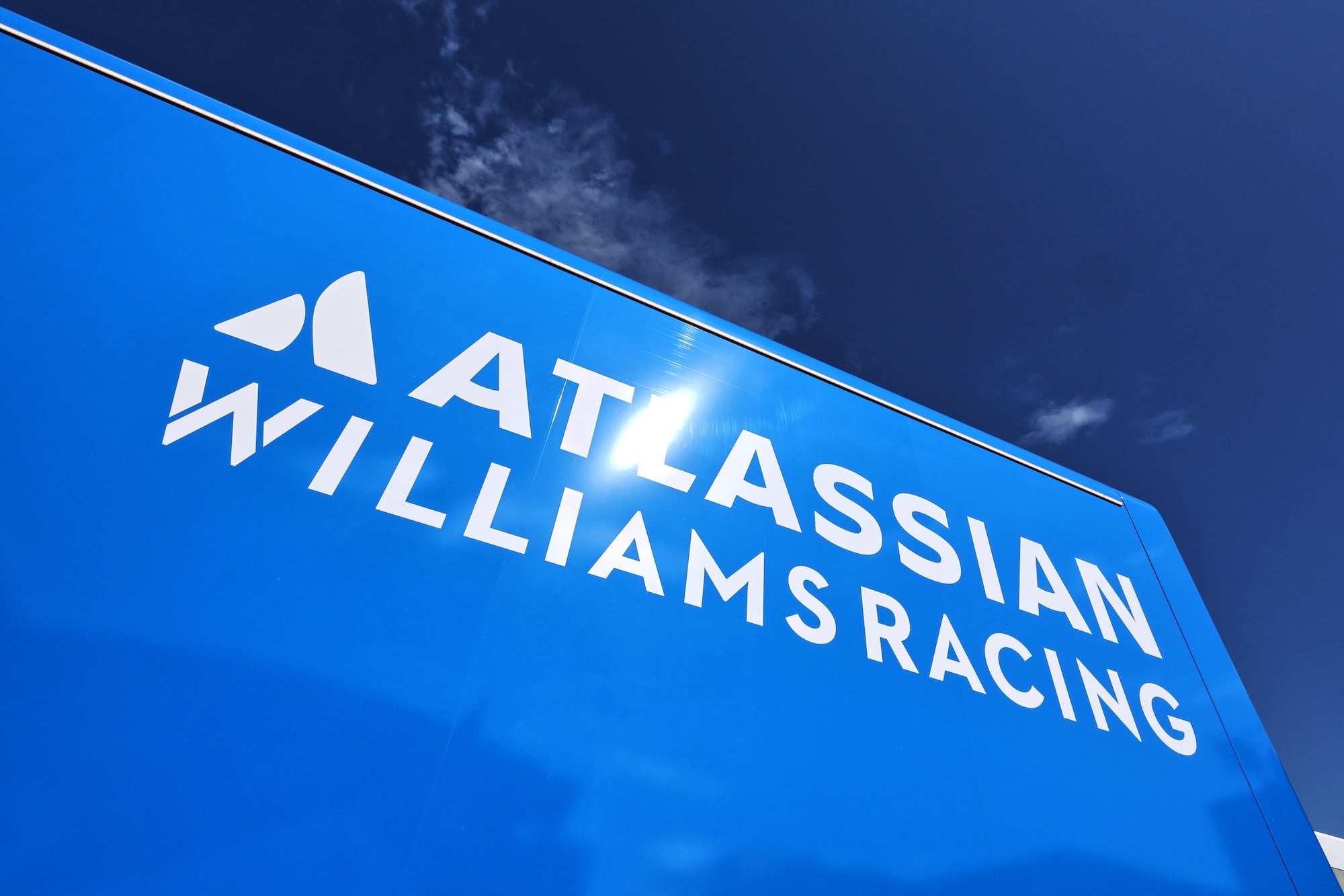 Atlassian Williams Racing logo on a truck in the paddock.