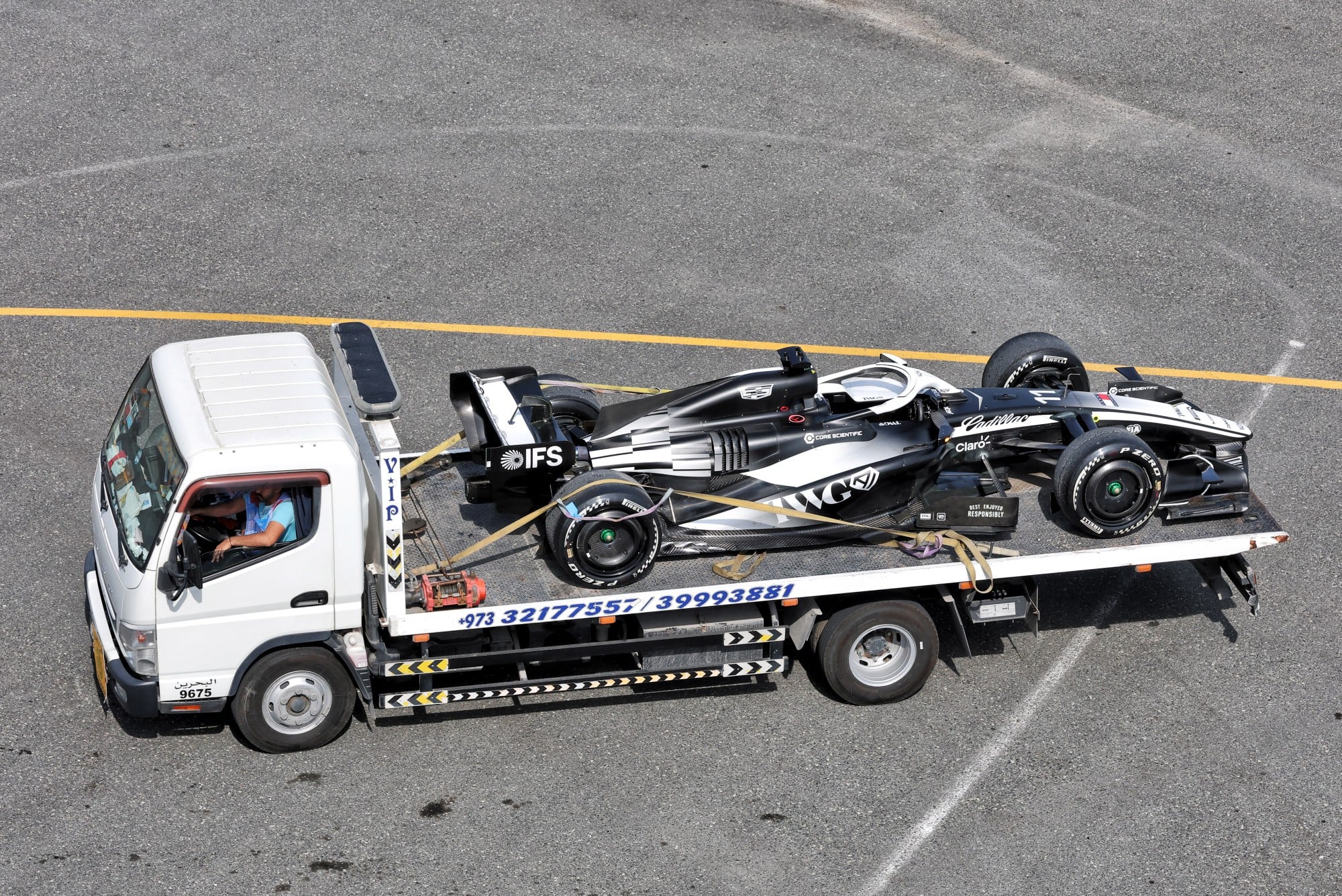 The Cadillac Formula 1 Team Car of Sergio Perez (MEX) is recovered back to the pits on the back of a truck.