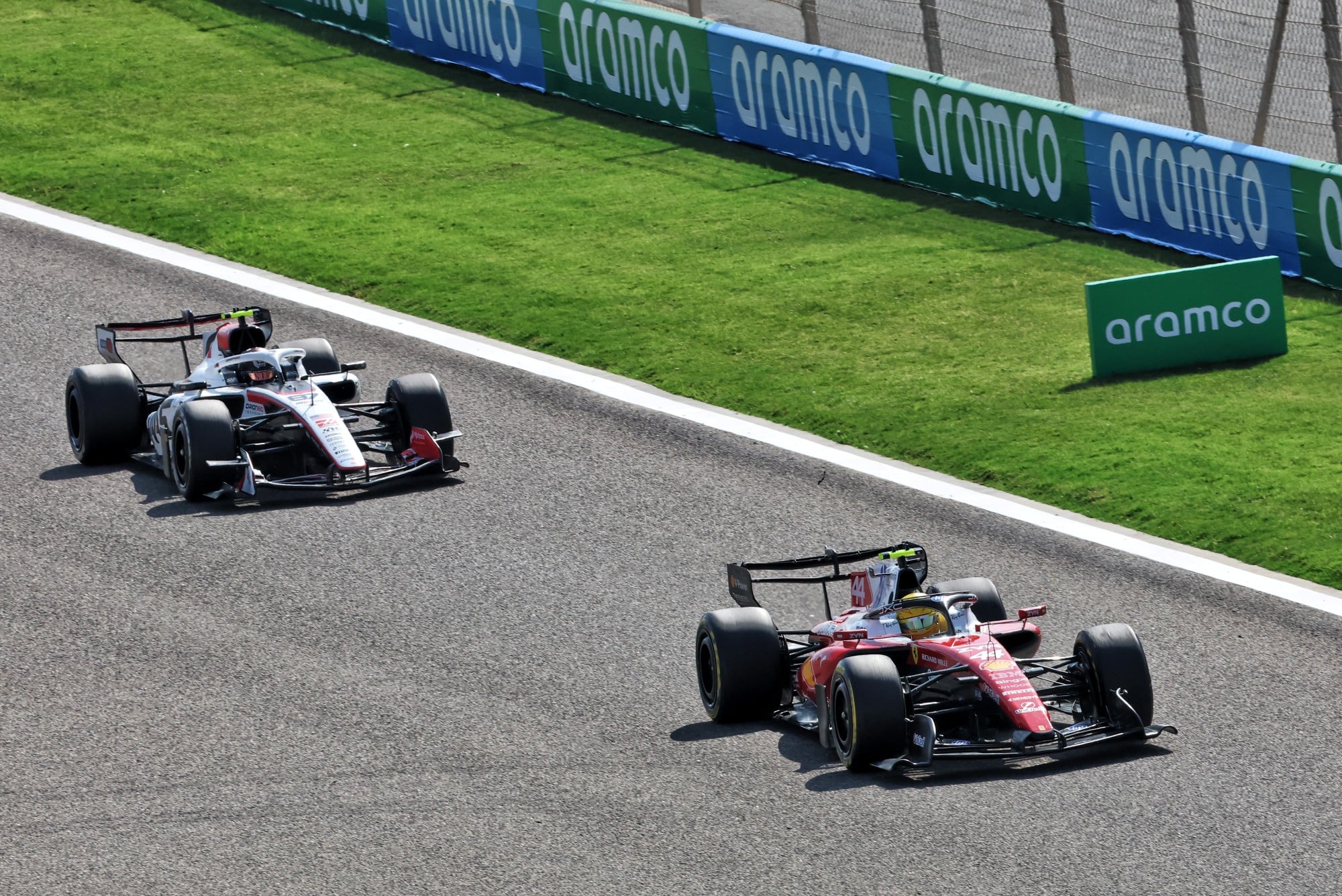 Lewis Hamilton (GBR) Scuderia SF-26 and Oliver Bearman (GBR) Haas F1 Team VF-26.