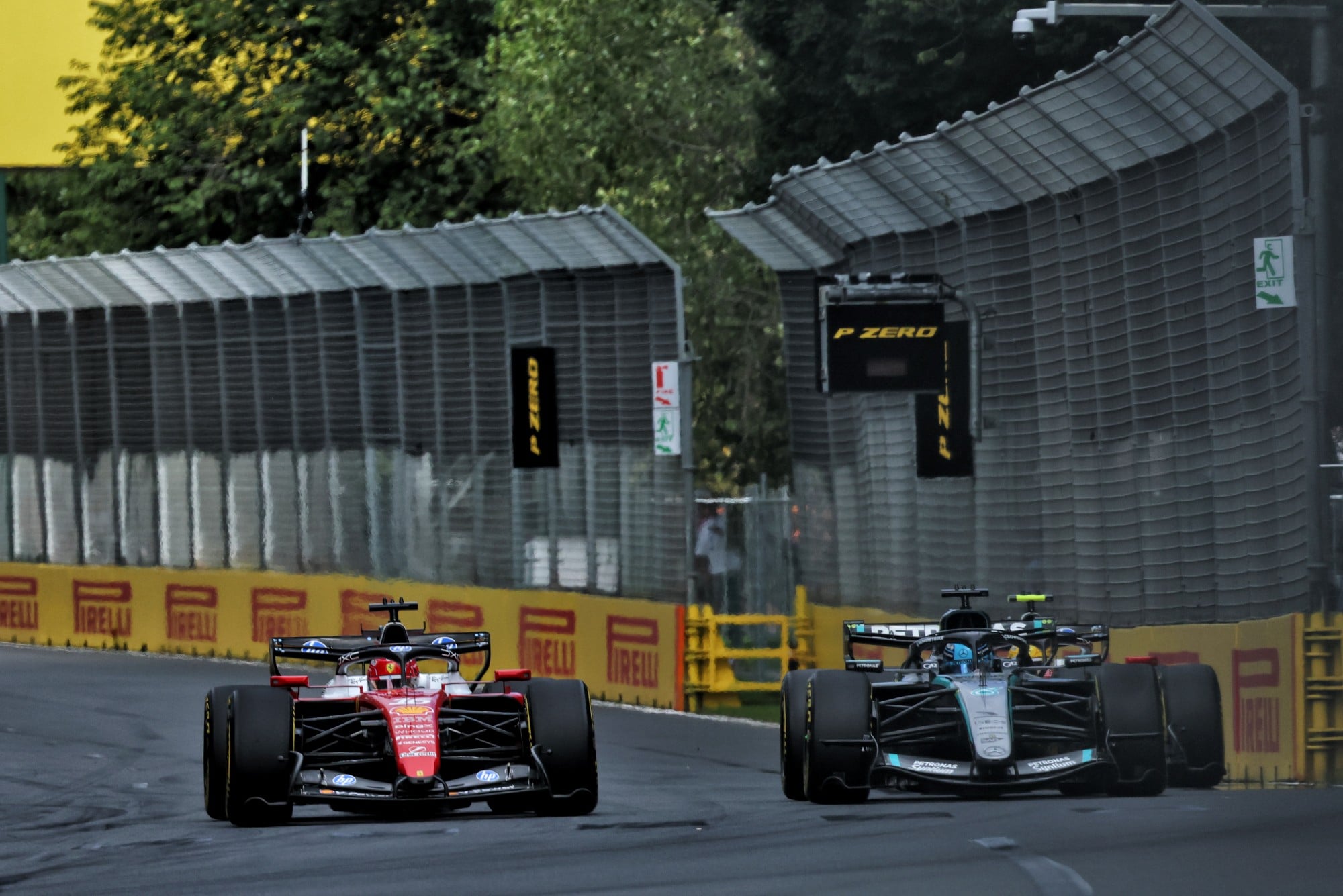 Charles Leclerc (MON) Scuderia Ferrari SF-26 and George Russell (GBR) Mercedes AMG Formula One Team W17 battle for position.