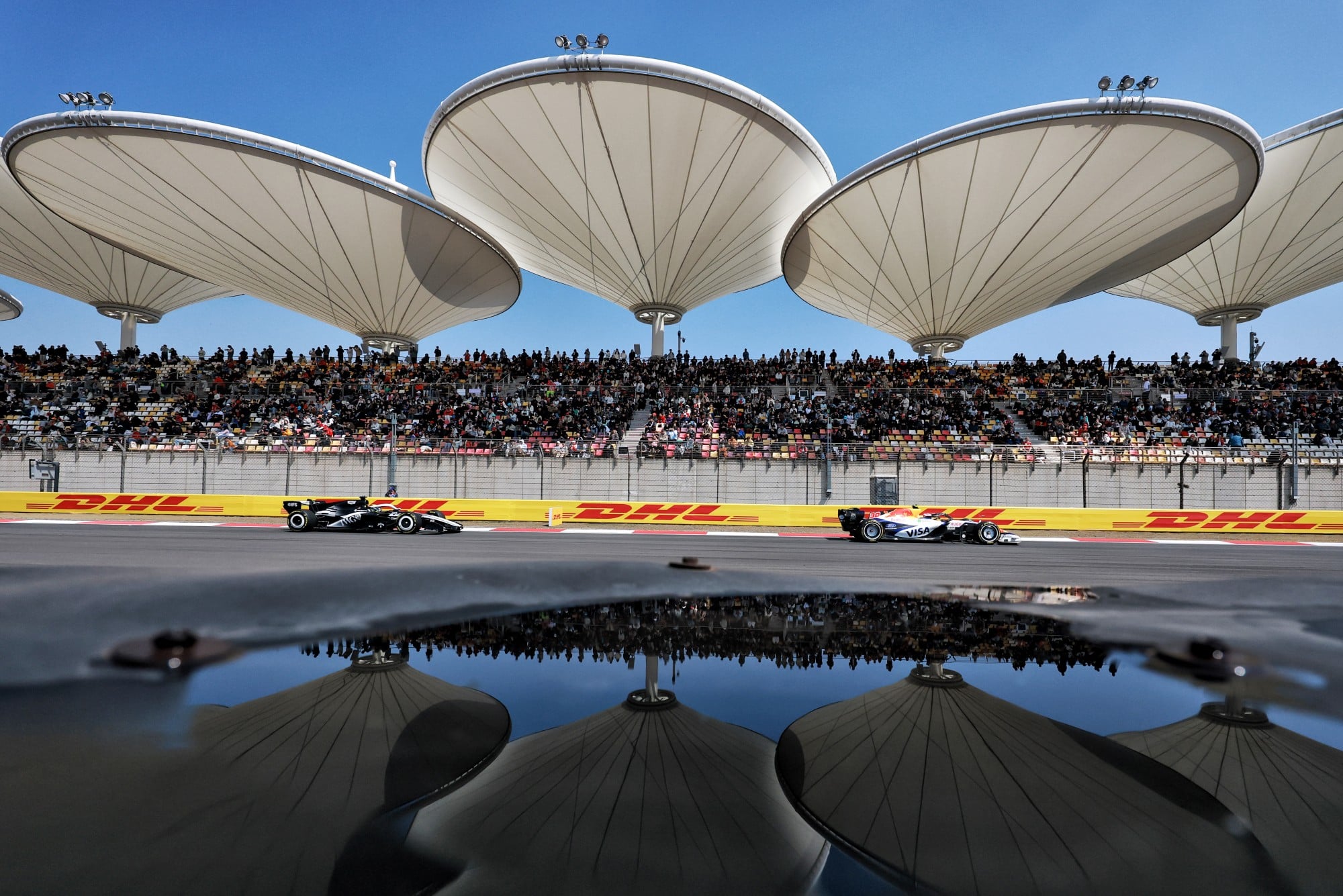 Liam Lawson (NZL) Racing Bulls Formula One Team VCARB 03 and Sergio Perez (MEX) Cadillac Formula 1 Team MAC-26.