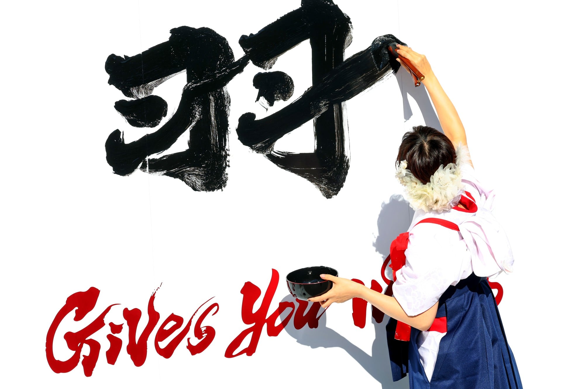 Paddock atmosphere - Racing Bulls Formula One Team Japanese script written on their pit garage boards.