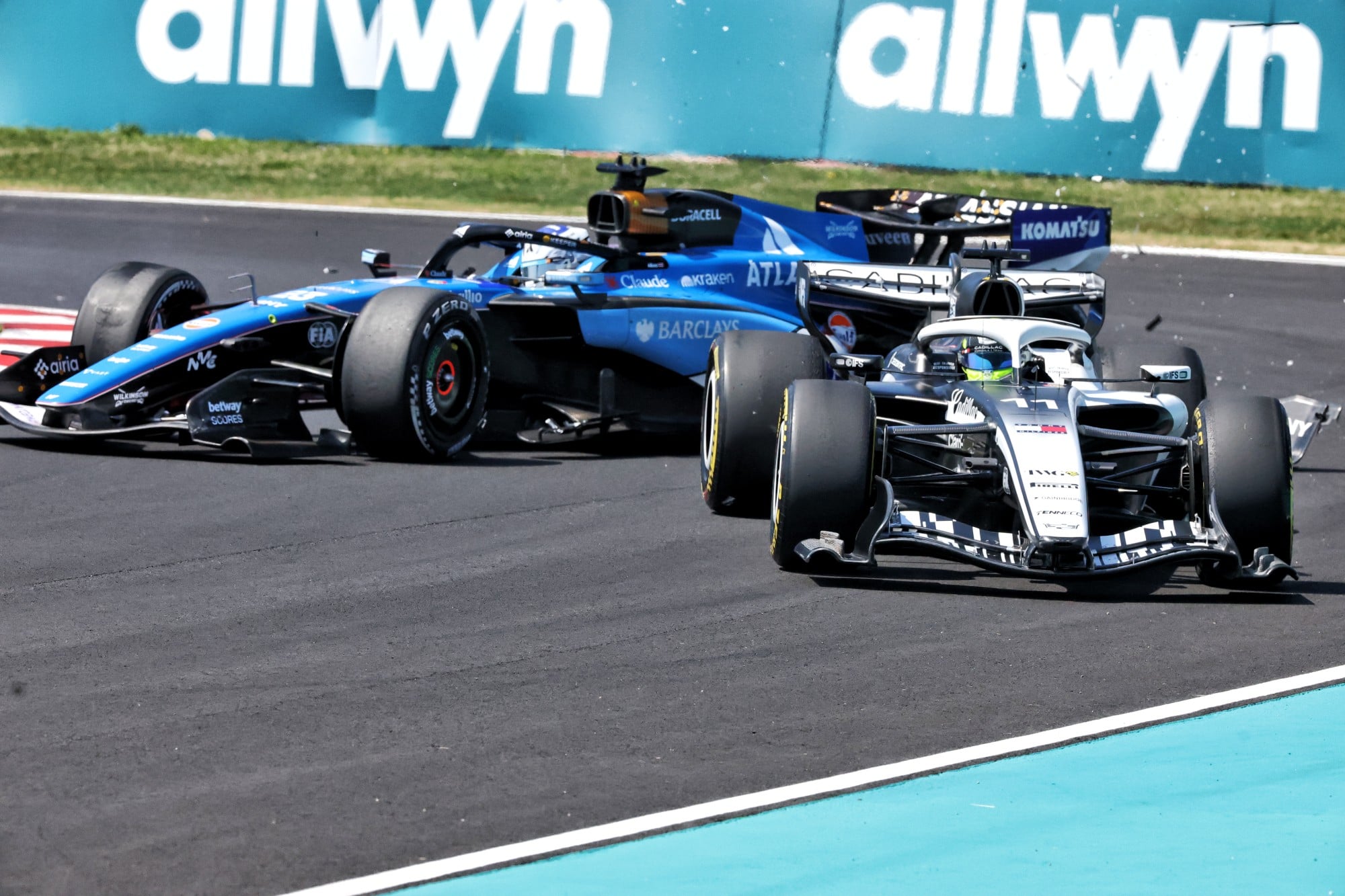 Alexander Albon (THA) Williams F1 Team FW48 and Sergio Perez (MEX) Cadillac Formula 1 Team MAC-26 collide in the first practice session.