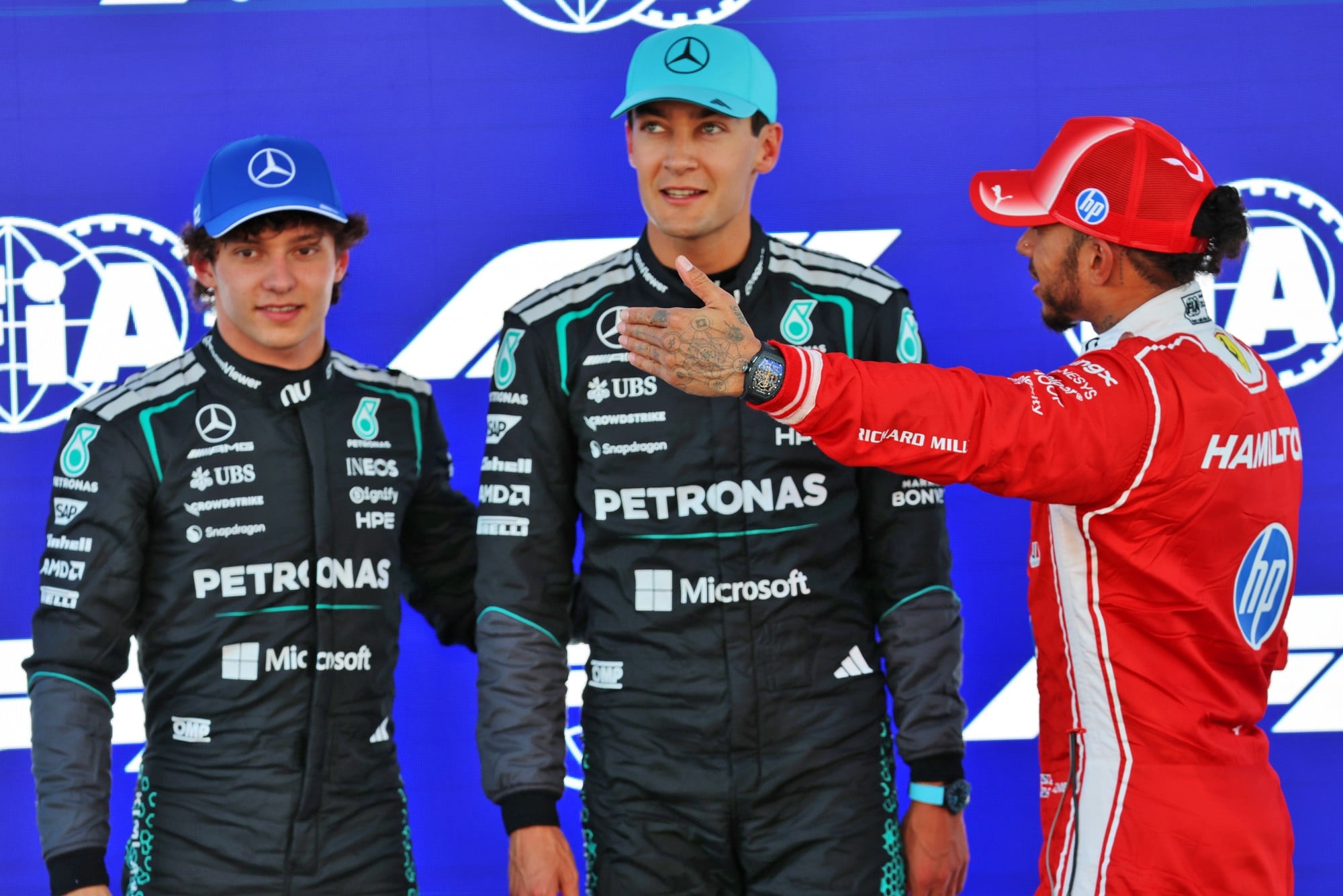 (L to R): Pole sitter George Russell (GBR) Mercedes AMG Formula One Team in qualifying parc ferme with third placed team mate Andrea Kimi Antonelli (ITA) Mercedes AMG Formula One Team and second placed Lewis Hamilton (GBR) Scuderia Ferrari.