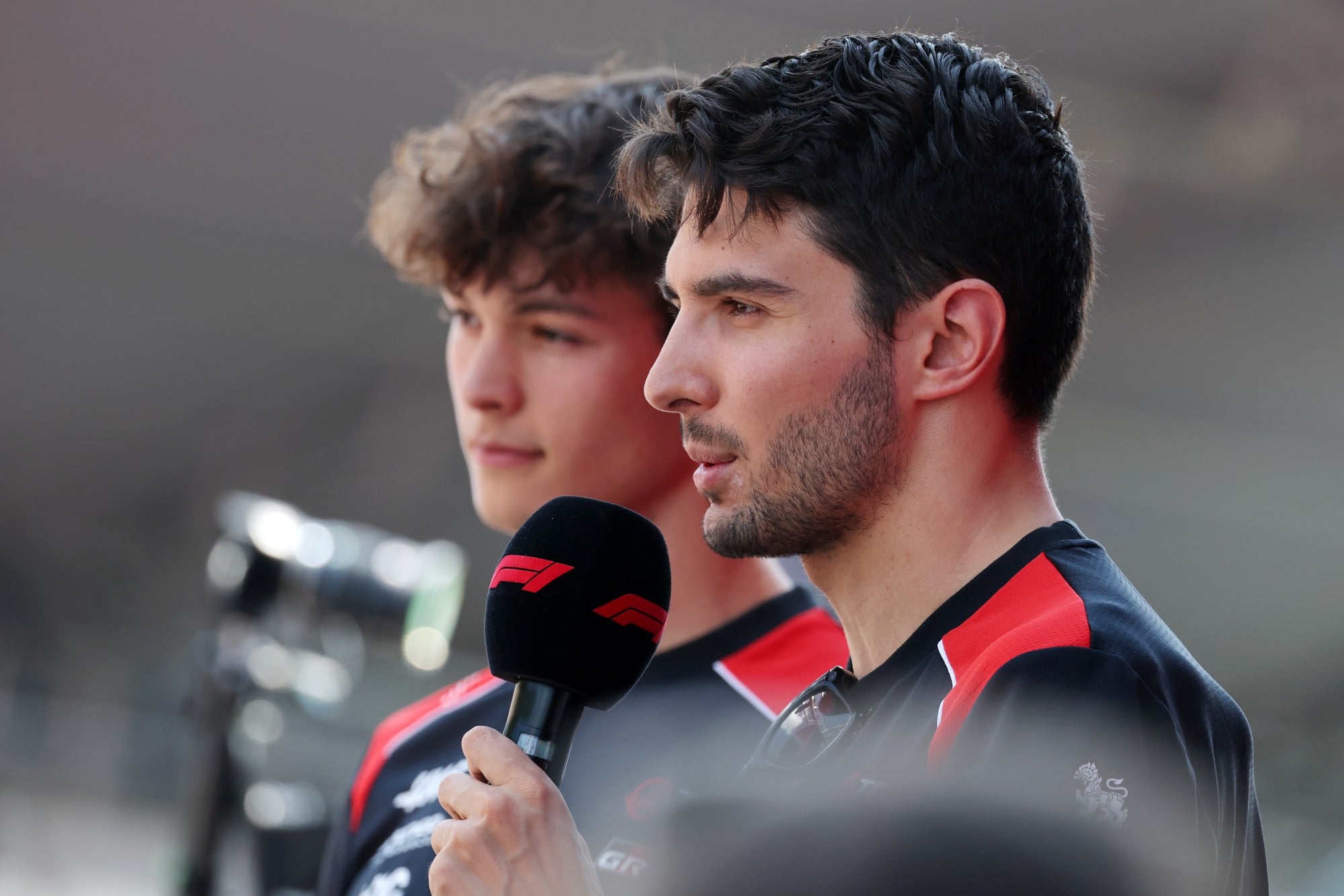 Esteban Ocon (FRA) Haas F1 Team and Oliver Bearman (GBR) Haas F1 Team on the FanZone Stage.