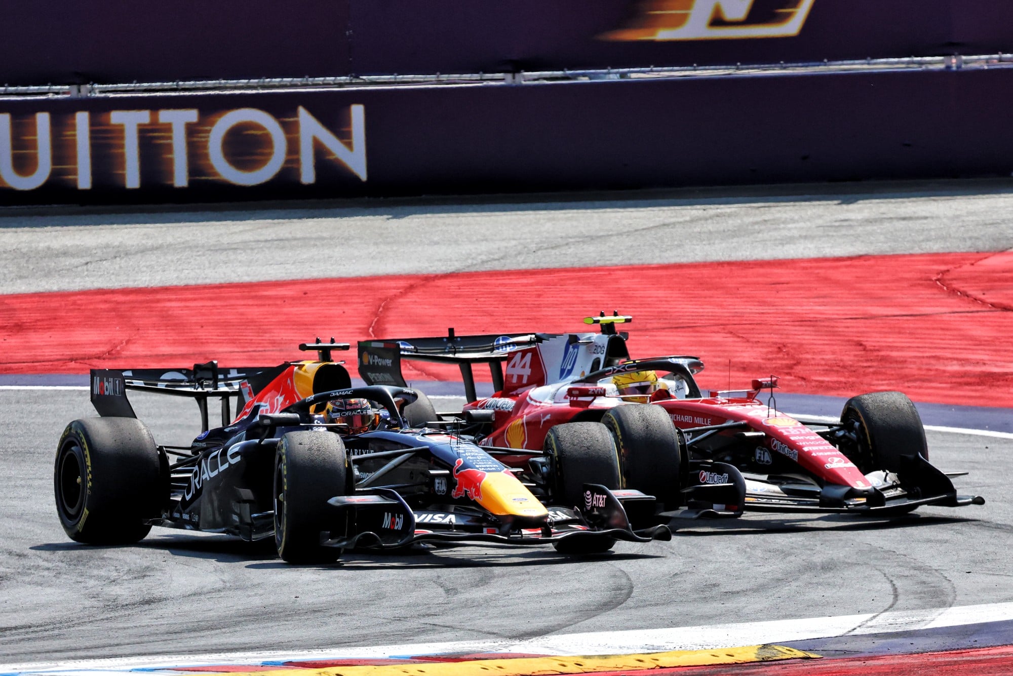 Lewis Hamilton (GBR) Scuderia Ferrari SF-26 and Max Verstappen (NLD) Red Bull Racing RB22 battle for position.