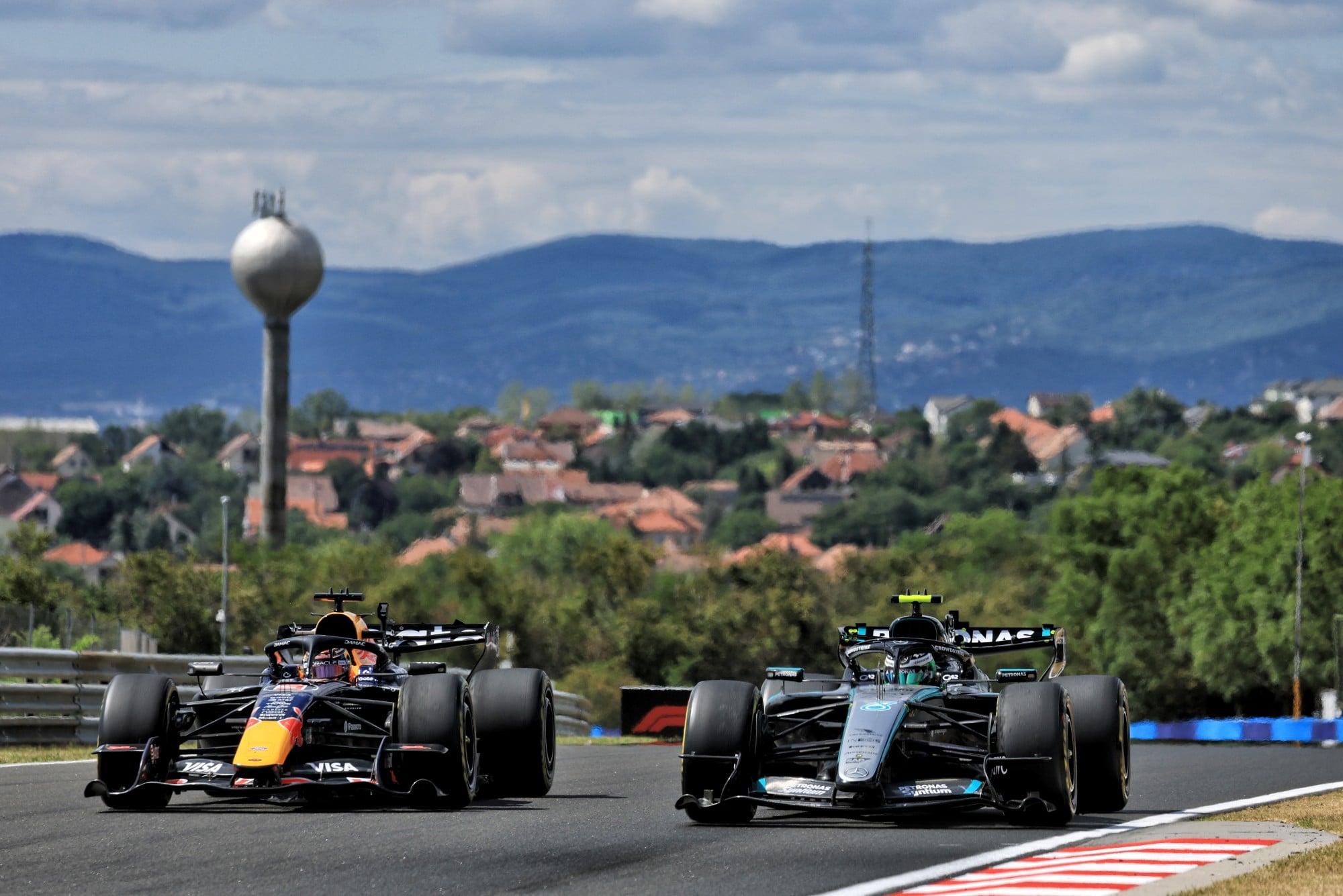Max Verstappen (NLD) Red Bull Racing RB22 and Frederik Vesti (DEN) Mercedes AMG Formula One Team W17 Reserve Driver.