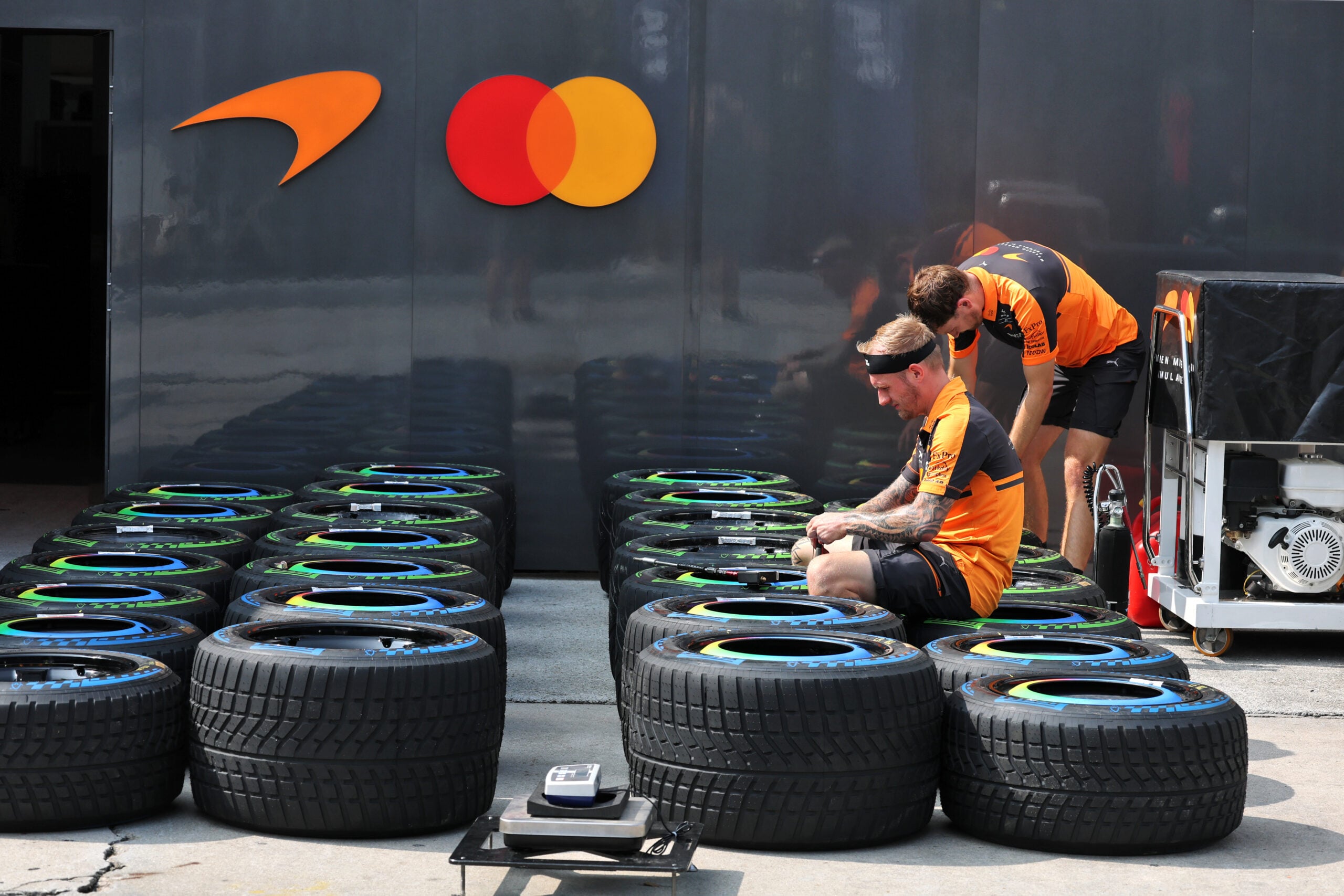 Paddock atmosphere - McLaren F1 Team mechanics with wet Pirelli tyres.