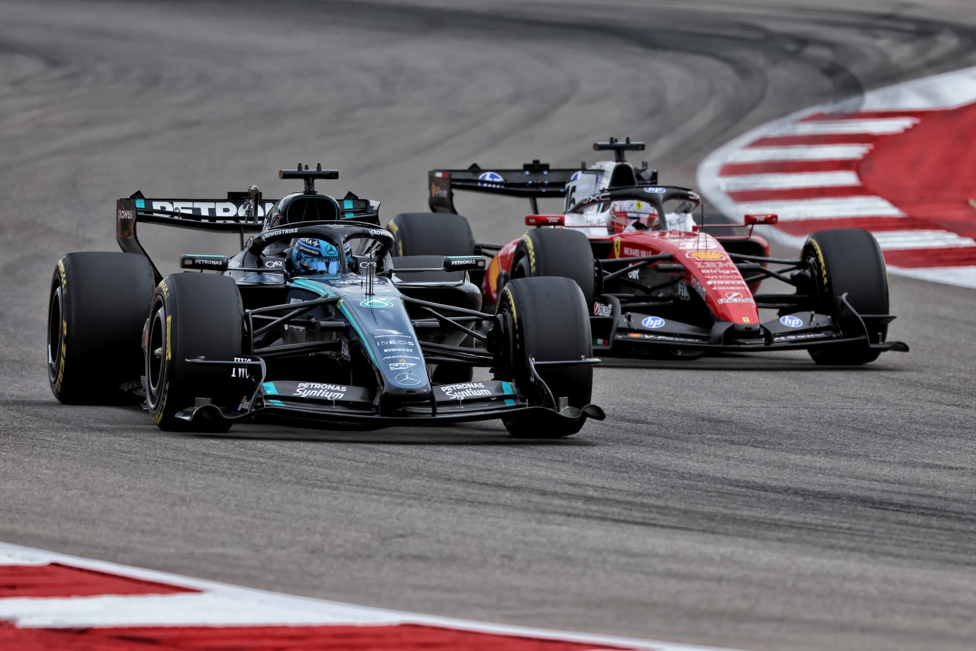 George Russell (GBR) Mercedes AMG Formula One Team W17 and Charles Leclerc (MON) Scuderia Ferrari SF-26 battle for position.